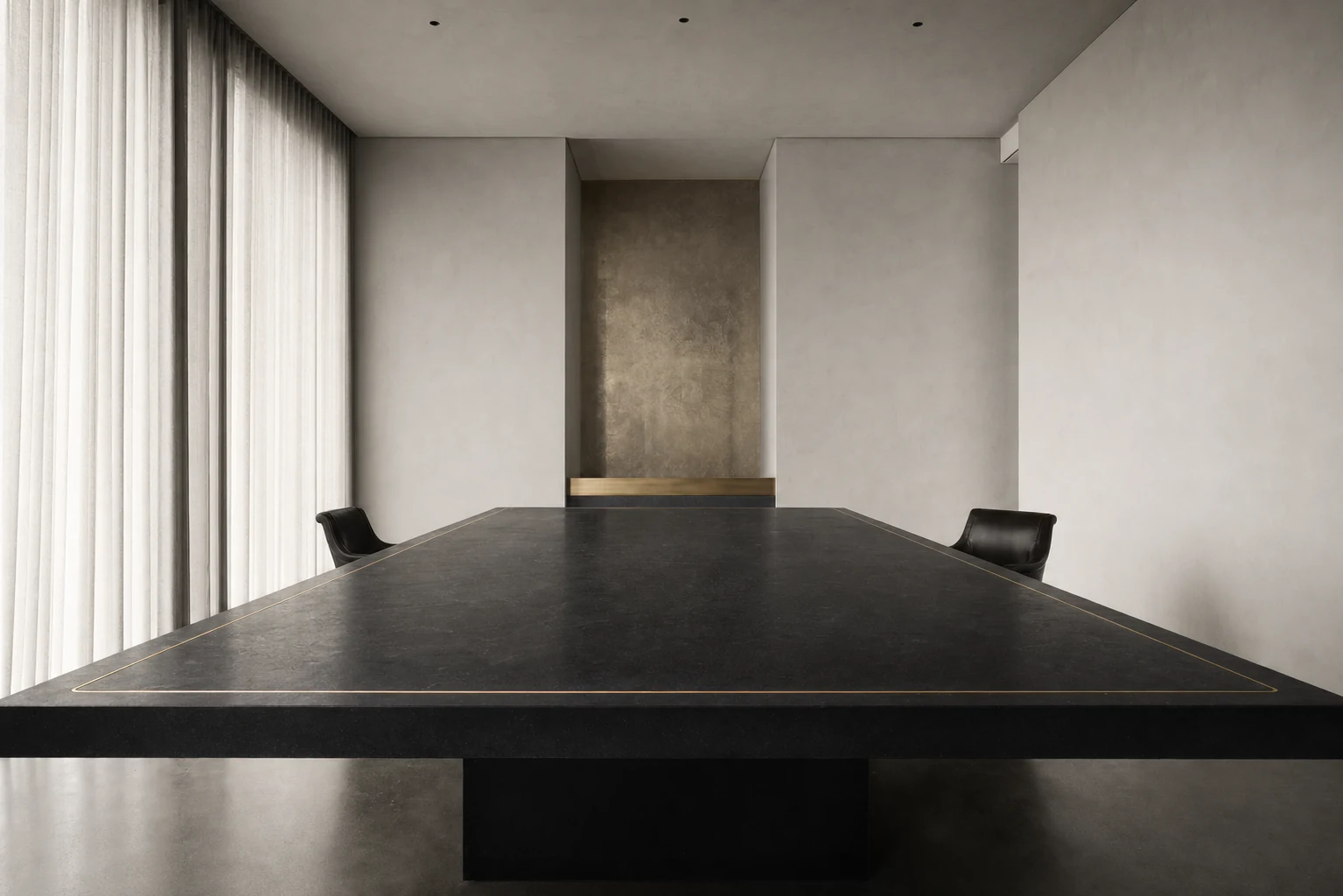 An empty private boardroom with a black stone table inlaid with a thin gold line
